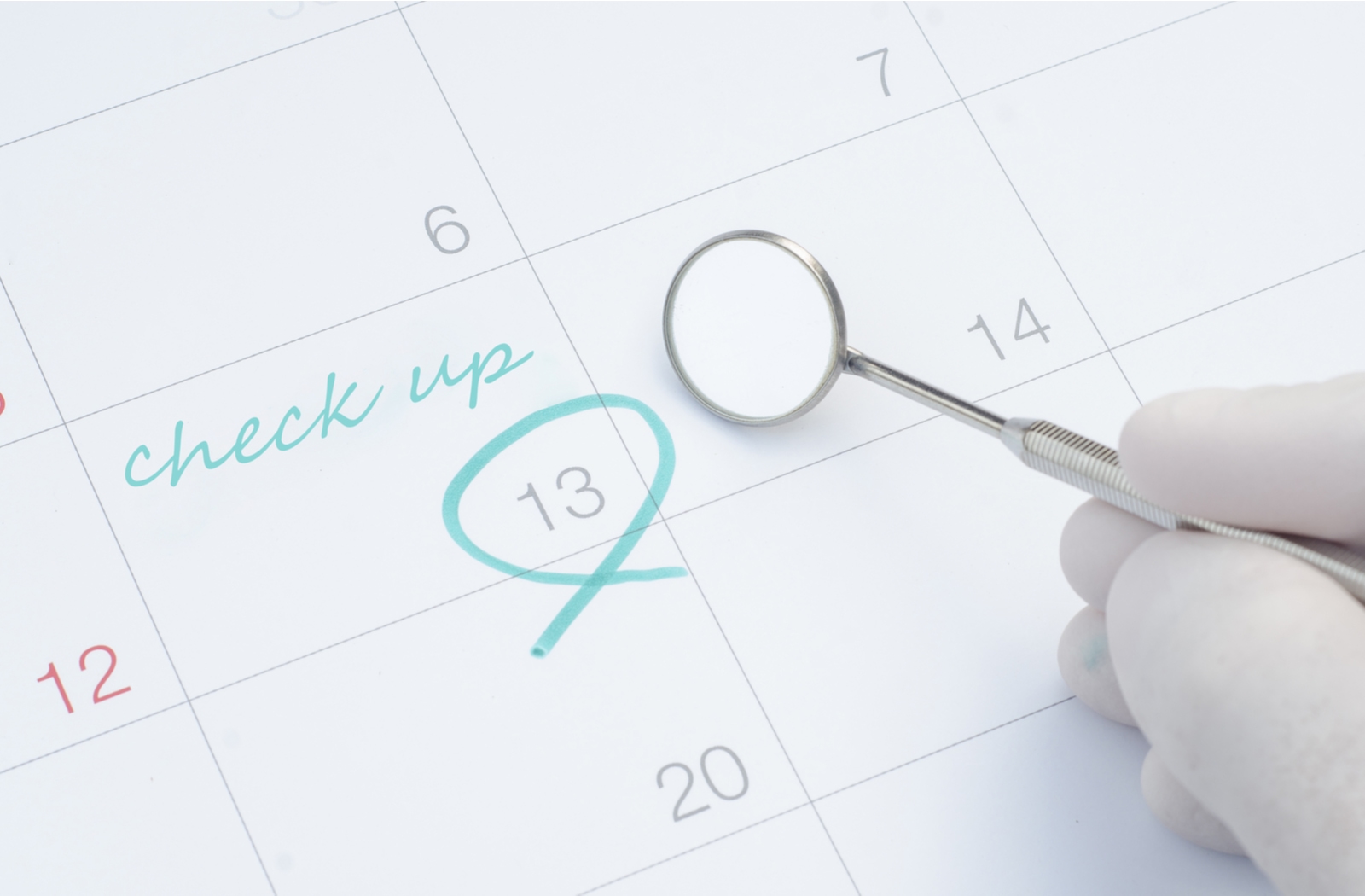 A note on a calendar from a dentist showing a date for a dental check-up