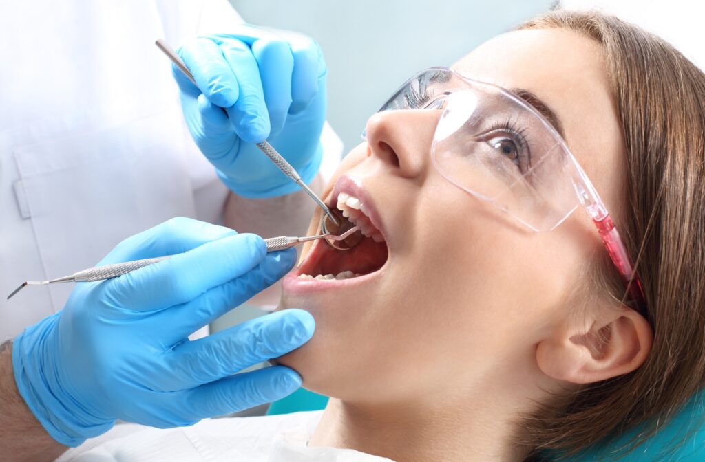 Woman in a dentist's chair getting a cavity filled