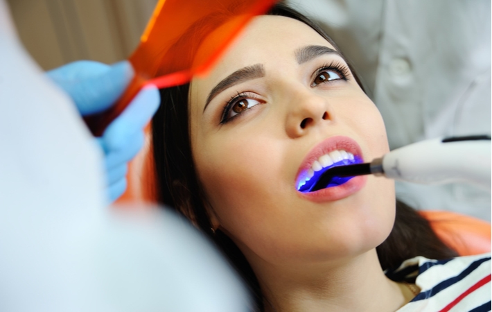 A woman at her dentist getting a dental filling