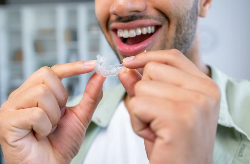 A patient using SureSmile clear aligners to help straighten their teeth alignment