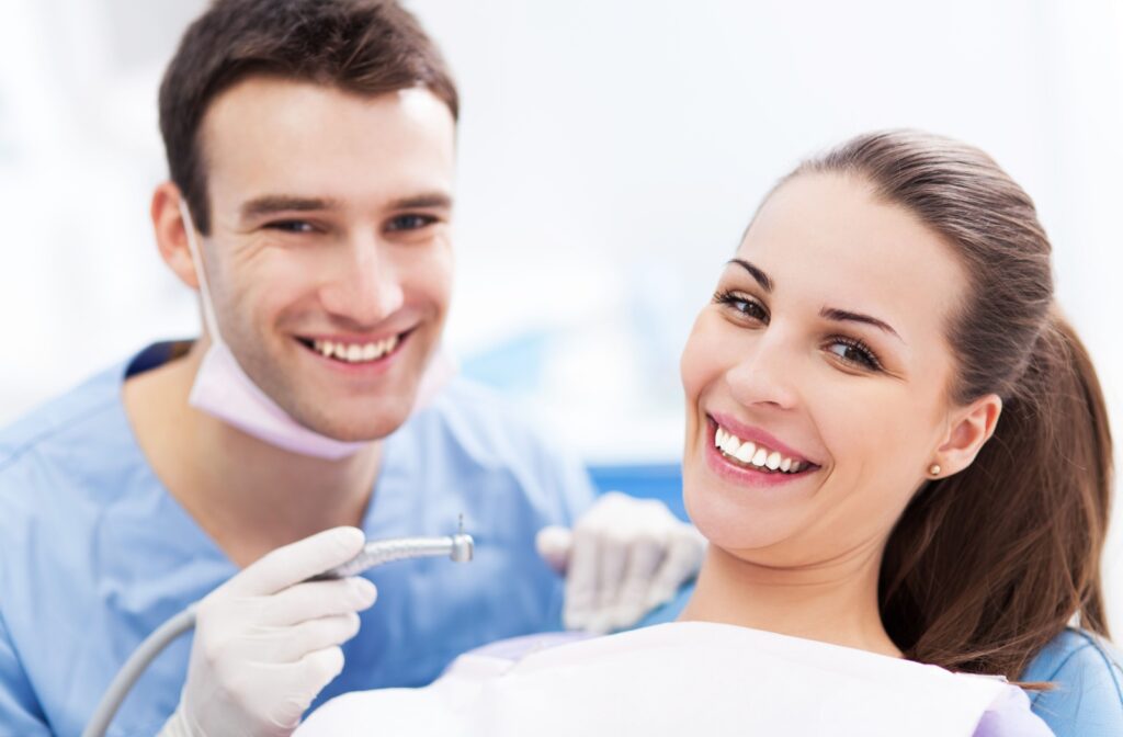 A dental hygienist and patient share a smile after a routine dental cleaning.
