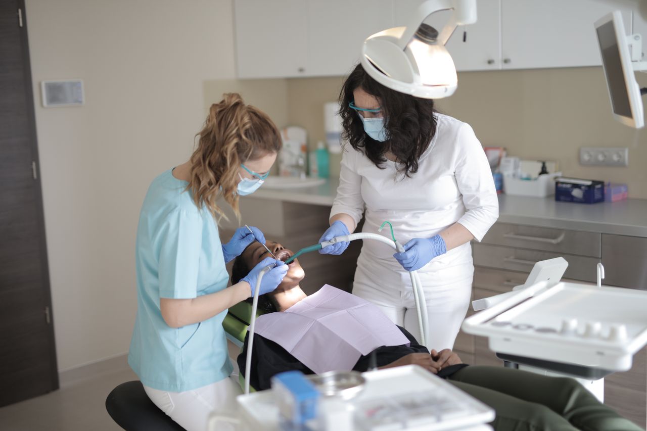 Dentists examining a patient with diabetes for gum health in Oakville