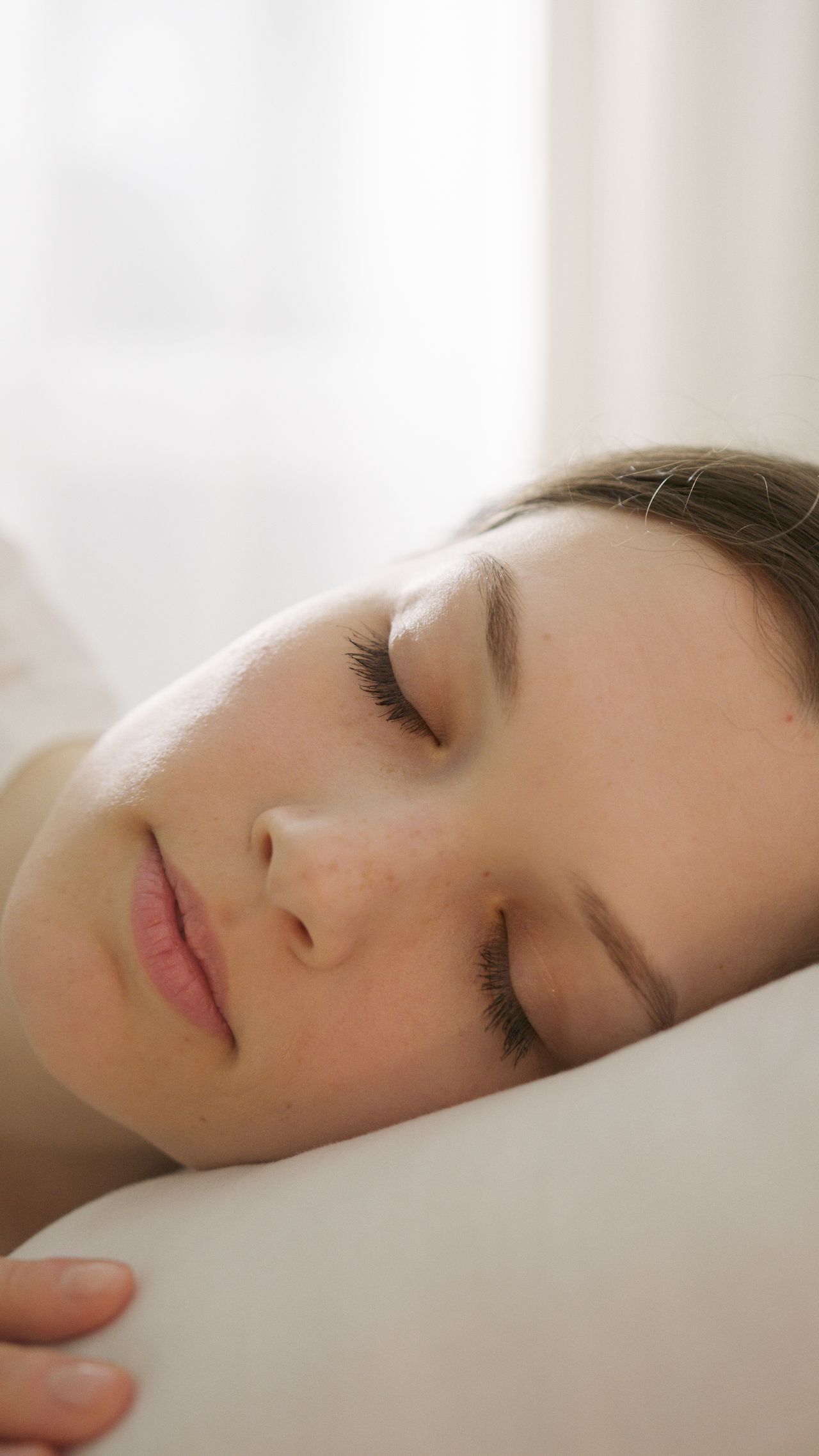 Woman sleeping peacefully to illustrate nighttime mouth breathing in Oakville