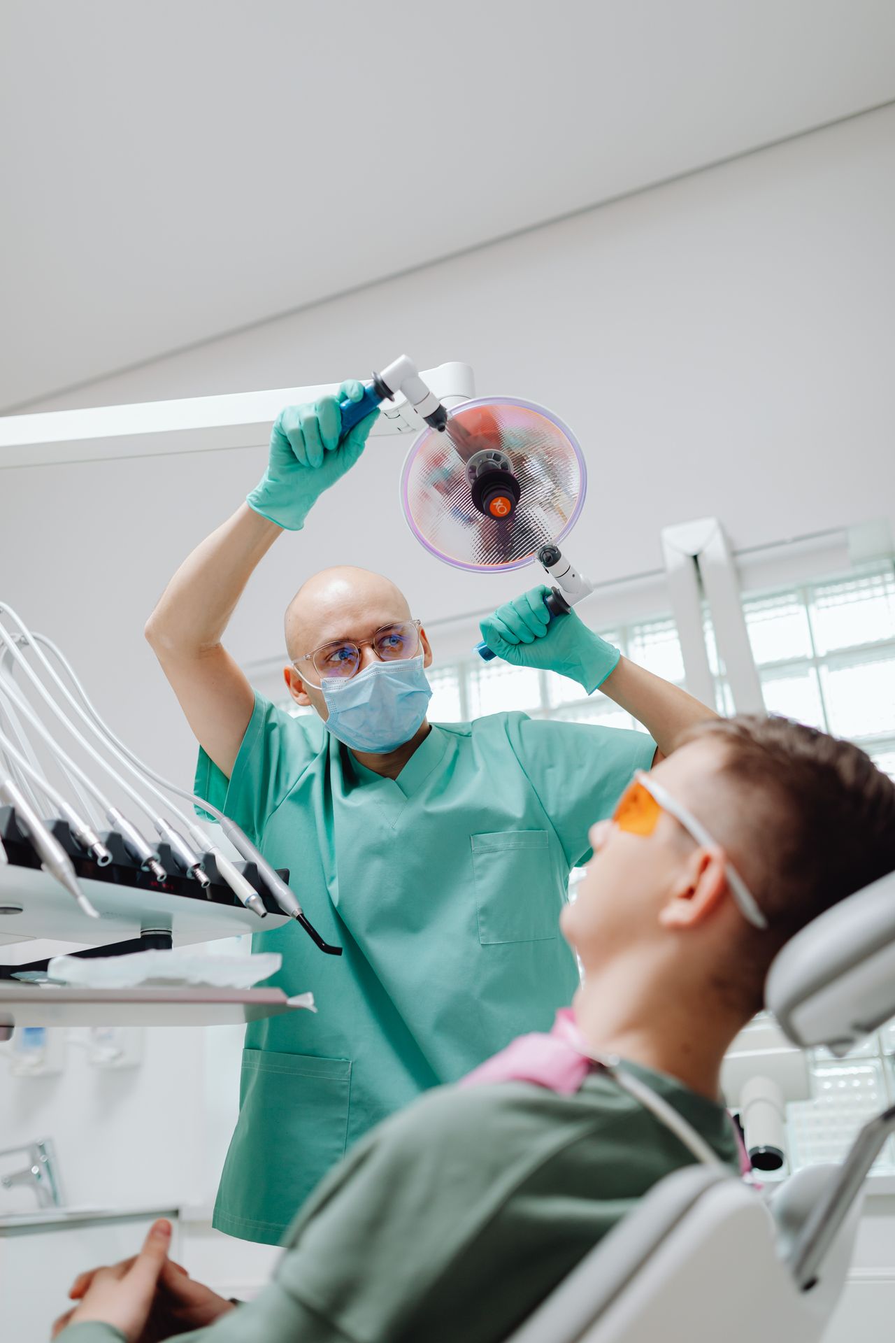 Dentist holding a ceramic dental crown before placement