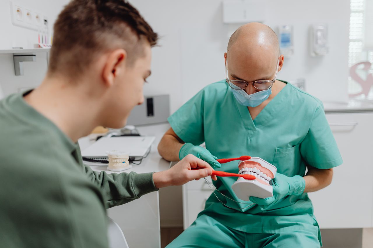 Dentist reviewing a 3D jaw scan before dental implant bone grafting