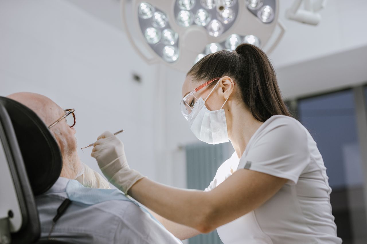 Dental hygienist performing a gentle deep cleaning on a patient