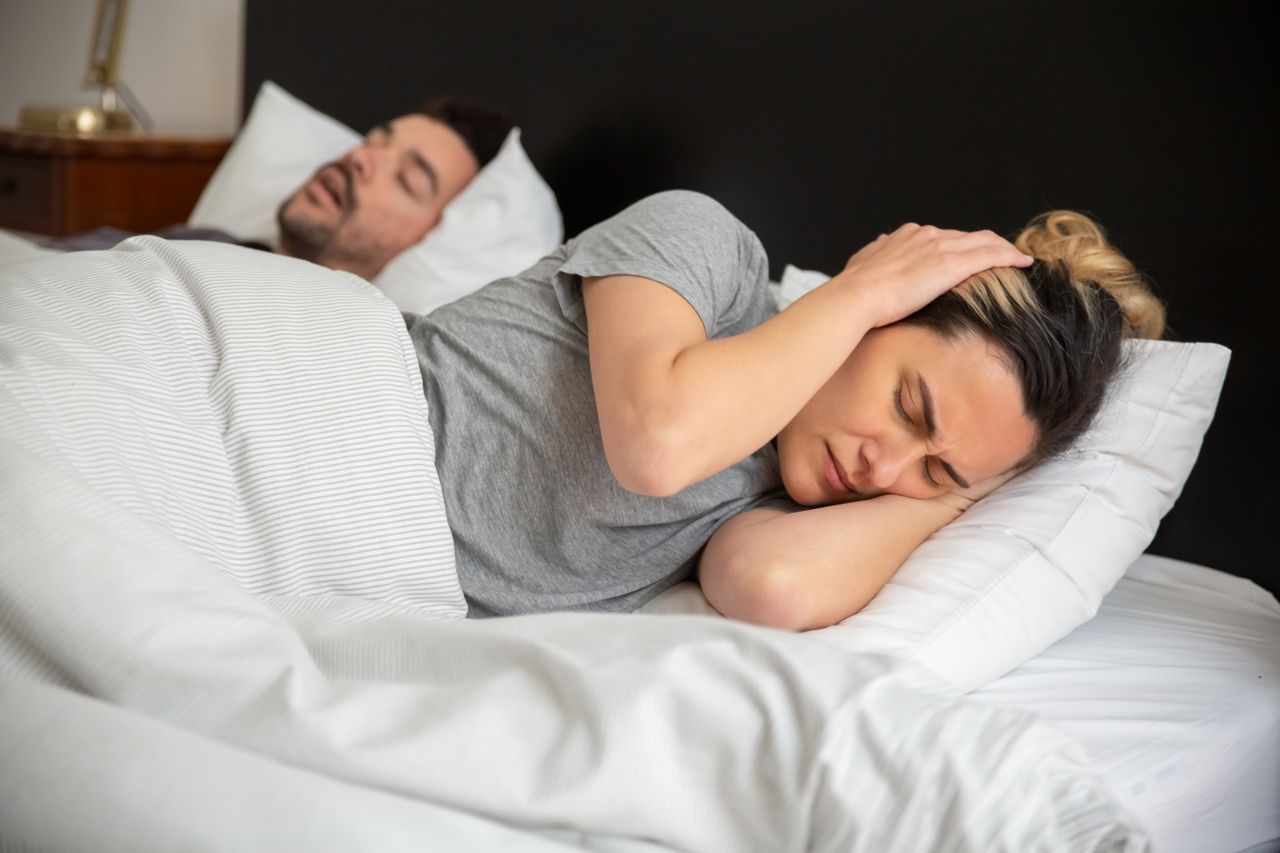 Frustrated woman trying to fall asleep
