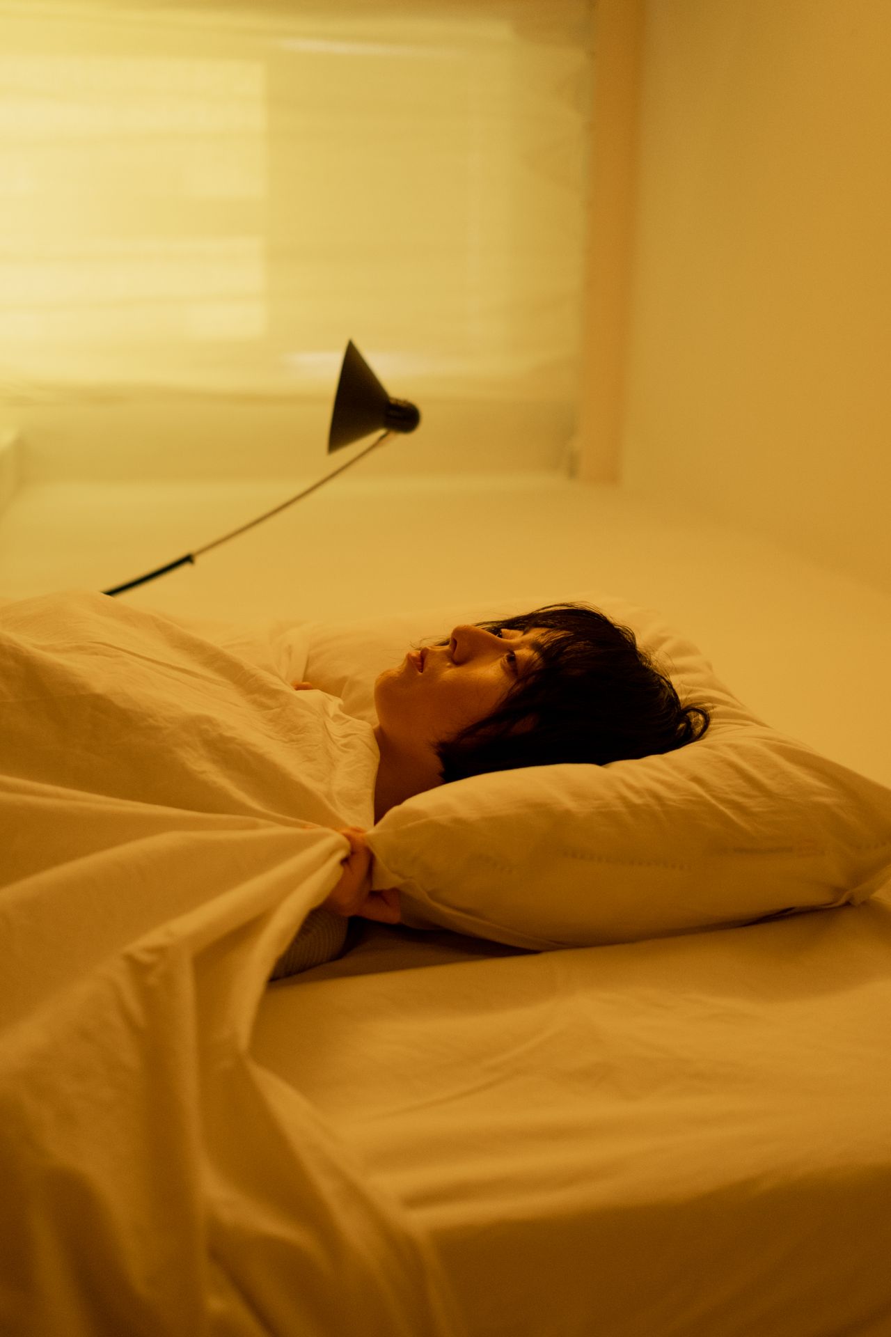 Tired woman lying on her bed in the morning